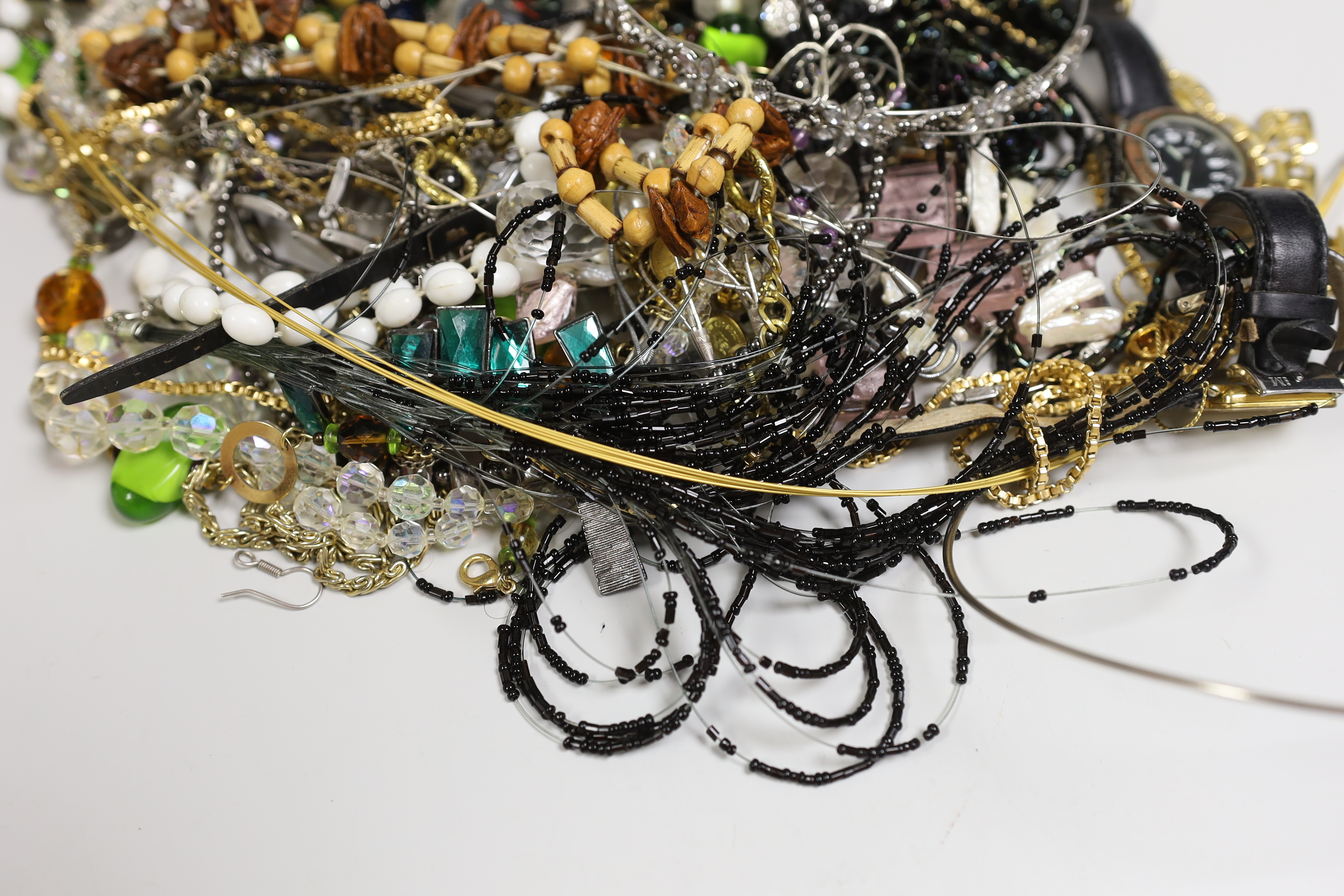 A box of costume jewellery including silver brooches and pendants.